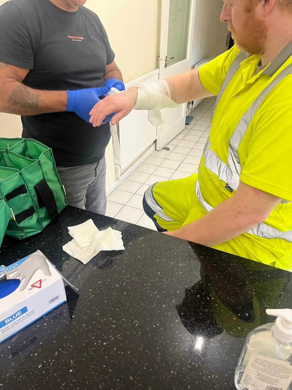Paul demonstrating practical bandaging during workplace first aid training